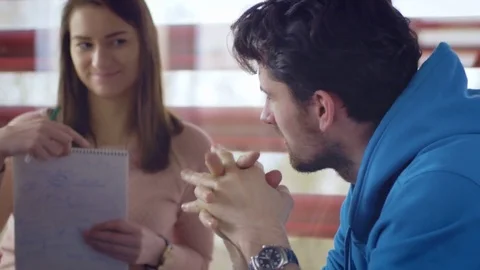 Group of students considering different ideas for a project at the university Stock Footage 75554445