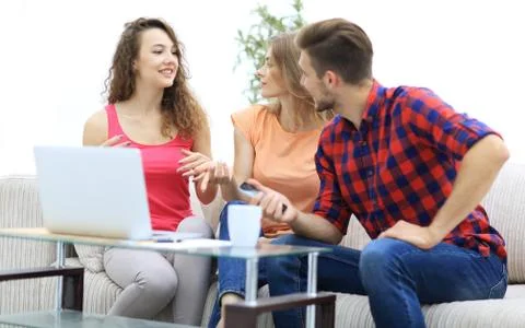 Group of students to discuss the problem sitting on the couch. Stock Photos
