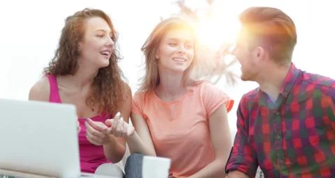 Group of students to discuss the problem sitting on the couch. Stock Photos