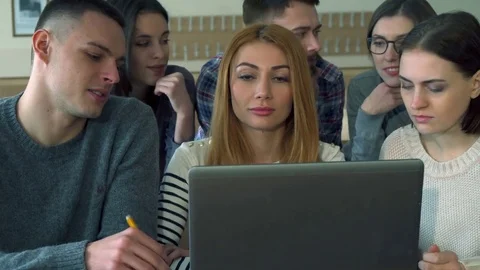 Group of students discusses something on laptop Stock Footage 73638769