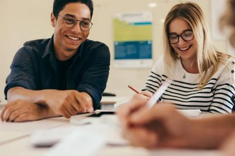 Group of students doing school assignment in classroom Stock Photos