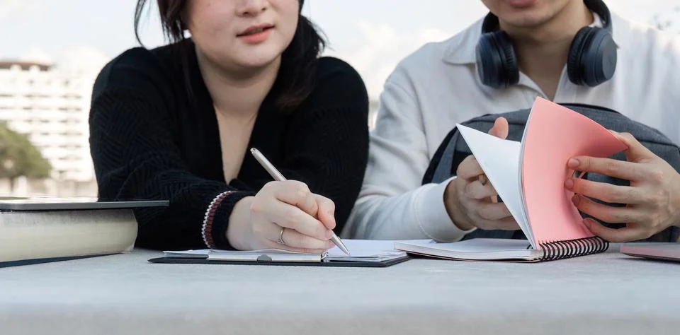 Group of Students Engaged in Online Learning Outdoors with Laptops and Notebooks Stock Photos