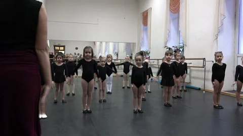 Group of students in the hall simultaneously repeat the movements of his teacher Stock Footage 66201243