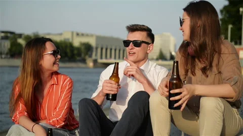 A Group Of Students Having Fun Outdoors. They Are Drinking Beer, Talking To Each Stock Footage 111769843