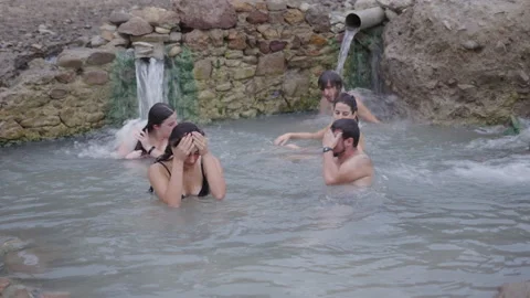 Group of students having fun under the jets in the river in Spain Video stock 221544848