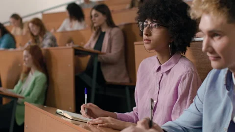 Group of students learns at lecture room. Young people study in university or pu Stock Footage 199483859