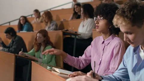 Group of students learns at lecture room. Young people study in university or pu Stock Footage 199483922