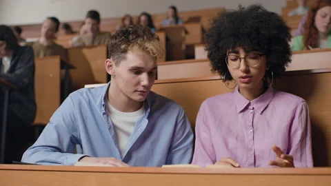 Group of students learns at lecture room. Young people studying in university or Stock Footage 199483937