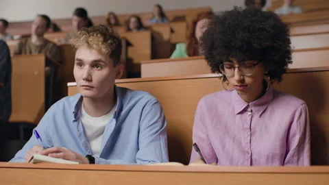 Group of students learns at lecture room. Young people study in university or pu Stock Footage 199483954