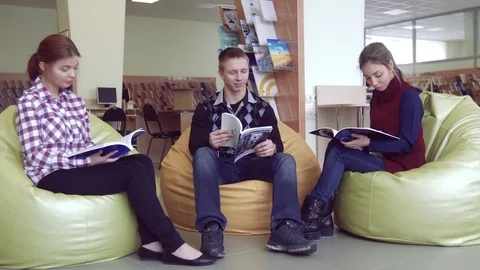 Group of students in library reading the books Stock-Footage 73311348