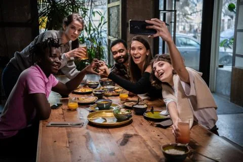 Group of students making faces, taking pictures with the smartph Stock Photos