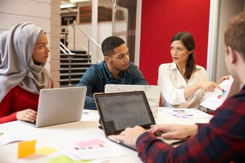 Group Of Students Meeting For Tutorial With Teacher Stock Photos