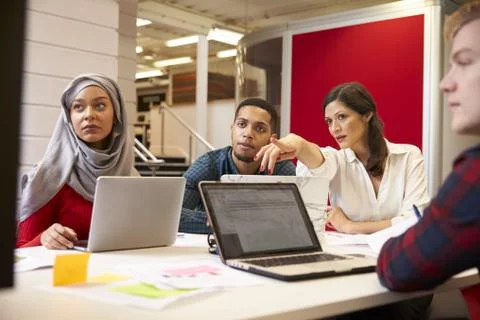 Group Of Students Meeting For Tutorial With Teacher Stock Photos