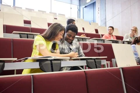 Group of students with notebooks at lecture hall Stock Photos