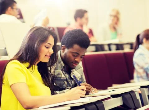 Group of students with notebooks in lecture hall Stock Photos