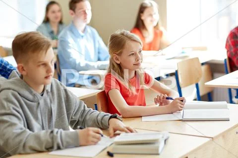 Group of students with notebooks at school lesson Stock Photos