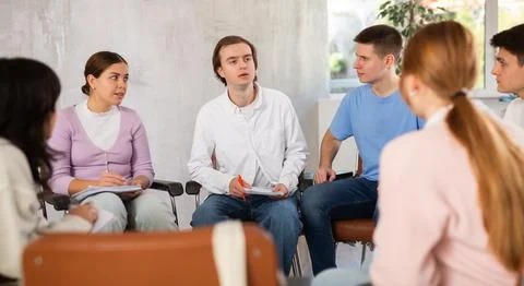 Group of students preparing for exam together in classroom of college Stock Photos
