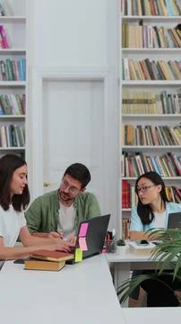 Group of students preparing for exam in university library. Happy diverse s.. Stock Photos
