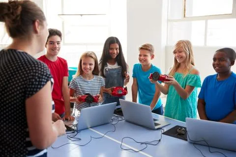 Group Of Students In School Computer Coding Class Learning To Program Robot Stock Photos