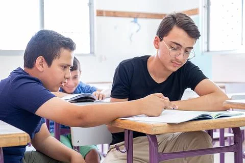 Group of students in school having discussion about some studying fields Stock Photos