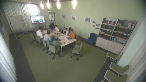 Group of students sits at big table in audience doing tasks Stock Footage 231861349