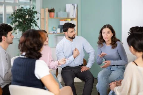 Group of students sitting in a circle and chatting Stock Photos