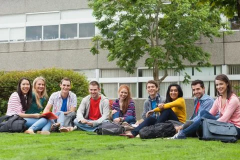 Group of students smiling at camera on the grass on campus Stock Photos