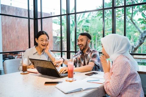 Group of students smiling happily while working together Stock Photos