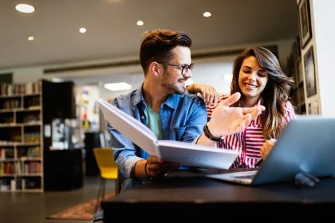Group of students study at library. Learning and preparing for university exam. Stock Photos