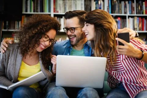 Group of students study at library. Learning and preparing for university exam. Stock Photos