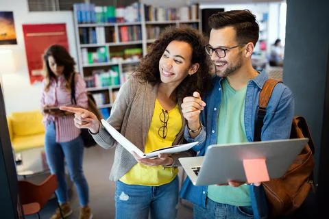 Group of students study at library. Learning and preparing for university exam. Stock Photos