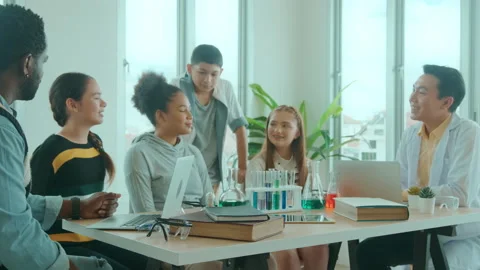 Group of students studying and playing with teacher, education and learning c Stockbeeldmateriaal 171172669