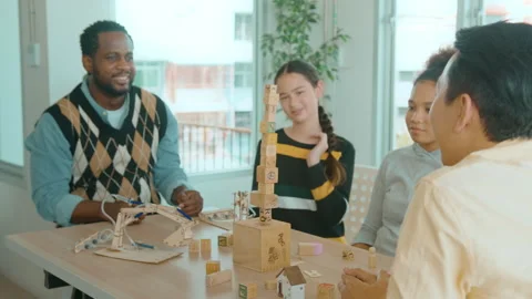 Group of students studying and playing with teacher, education and learning c Stockbeeldmateriaal 171174238