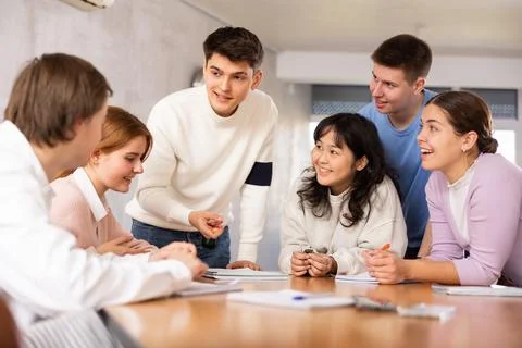 Group of students studying for difficult test in studygroup together Stock Photos