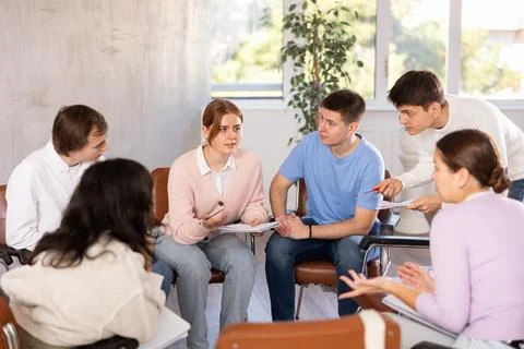 Group of students studying for difficult test in studygroup together Stock Photos