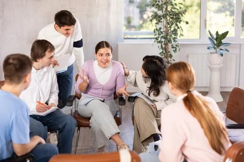 Group of students studying for difficult test in studygroup together Stock Photos