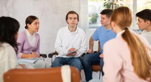 Group of students studying for difficult test in studygroup together Stock Photos