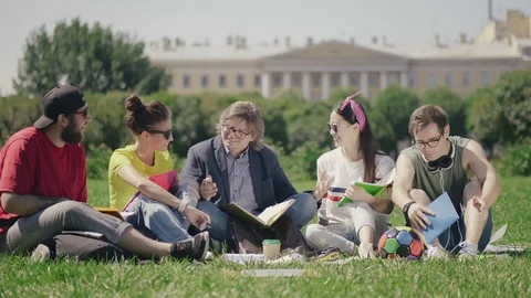 Group of students studying outside with a teacher. Stock Footage 98875822