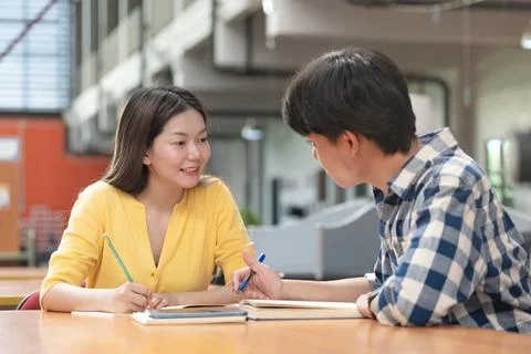 Group of students studying together in library. Two Asian students learning.. Stock-Fotos