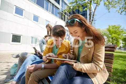 Group of students with tablet pc at school yard Stock Photos