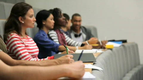 Group of students taking notes in lecture theatre Video stock 829343