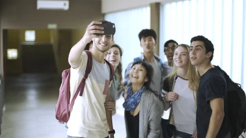 Group of students taking selfie with smartphone in corridor Stock Footage 106317517