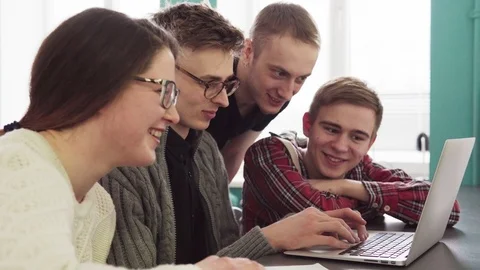 Group of students talking and looking at laptop screen Stock Footage 85995081