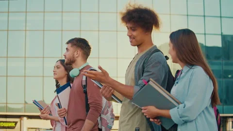 A Group of Students Talking Walking With Books at Background of College. Stock Footage 241298126