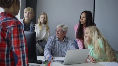 Group of students with teacher discussing study task on computer Stock Footage 142500078