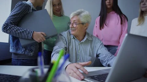 Group of students with teacher discussing study task on computer Stock Footage 142502100