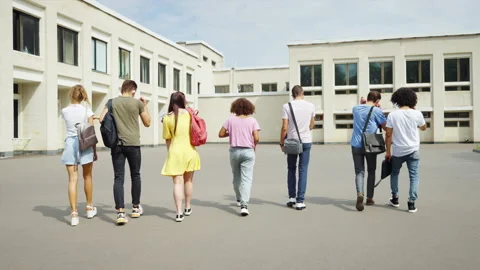 Group of students throwing masks in the air and running to college Stock Footage 166833639