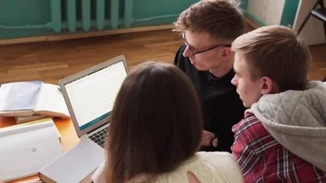 Group of students together learn and look at laptop screen Stock Footage 85906156