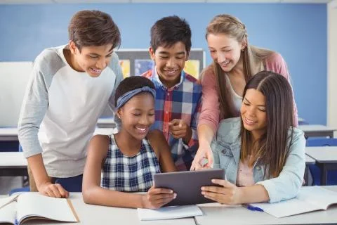 Group of students using digital tablet in classroom Foto stock