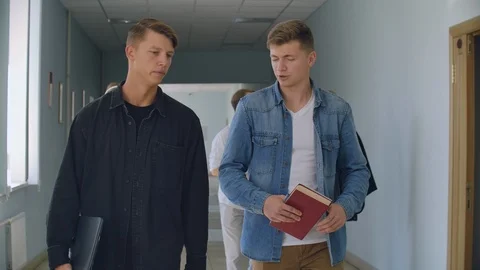 A group of students walk along the corridor of the university, school, college Stock Footage 116178660